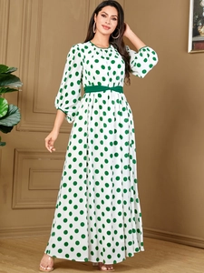 Elegant white maxi dress with green polka dots featuring lantern sleeves and a belted waist