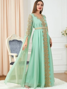 Detailed golden embroidery on mint green Moroccan kaftan with cape-style split sleeves