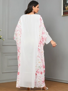 Close-up of lightweight white chiffon kaftan with pink floral print and batwing sleeves