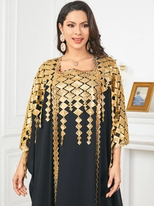 Close-up of elegant gold sequin geometric embroidery on black long-sleeved kaftan dress