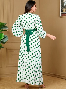 Elegant white maxi dress with green polka dots, puff sleeves and a matching waist belt