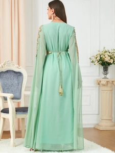 Rear view of mint green chiffon gown with gold embroidery and cape sleeves