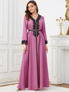 Detail of pink long sleeve dress with black polka dots, lace embroidery and gold buttons