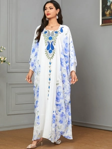 Detailed embroidery and blue floral print on white kaftan dress with batwing sleeves