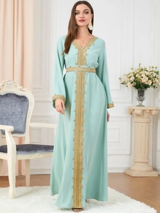 Detailed view of mint green kaftan dress featuring intricate gold lace embroidery and waist tie
