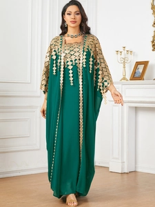 Detail view of emerald green chiffon dress with luxury gold sequin diamond embroidery