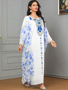 Elegant white kaftan dress with blue floral print and intricate embroidery details