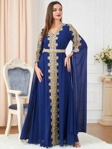 Detail of navy blue kaftan dress showing gold lace embroidery and chiffon fabric texture