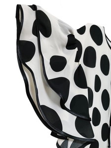 Detail of ruffled sleeves with black piping and large polka dot print on lightweight fabric