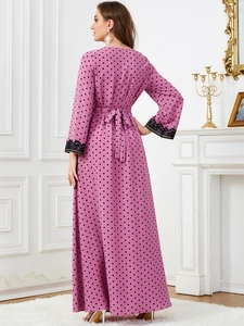 Pink polka dot maxi dress featuring black lace cuffs and a matching waist tie detail