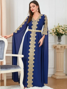Detailed golden lace embroidery and split cape sleeves on a navy blue kaftan gown