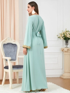 Detail of mint green long robe featuring gold floral embroidery on the cuffs and waist tie