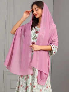 Detail of light pink semi-transparent chiffon shawl with floral dress texture and drape
