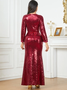 Detail of red sequin evening gown showing the slim fit back design and delicate lace-up straps