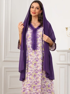 Detail of elegant V-neck floral dress with purple buttons and chiffon hijab accessory