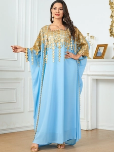 Close-up of golden embroidery and tassels on light blue elegant kaftan sleeve