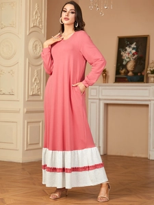 Elegant coral pink and white crew neck long sleeve dress with side pockets and ruffle hem