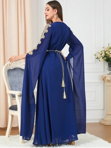 Detail of royal blue chiffon dress with gold sequin embroidery and split long sleeves