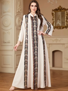 Elegant beige V-neck long sleeve kaftan dress with ethnic embroidery and gold details