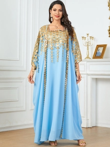 Close-up of sky blue kaftan featuring intricate gold geometric embroidery and sequins