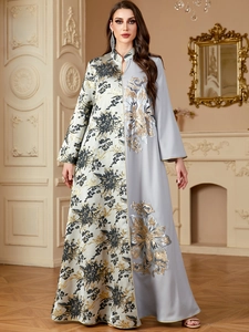 Detailed close-up of sequin floral embroidery and jacquard patchwork on V-neck kaftan