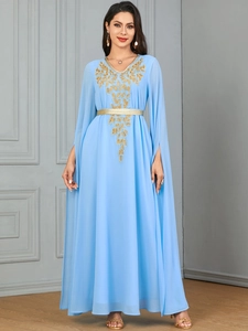 Detail of light blue chiffon maxi dress with gold sequin leaf embroidery and cape sleeves