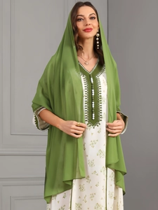 Detail of green chiffon kaftan robe with dark green V-neck embroidery and buttons
