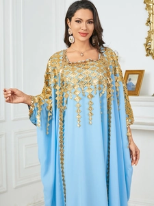 Detailed close-up of sky blue kaftan with intricate gold diamond embroidery and sequins