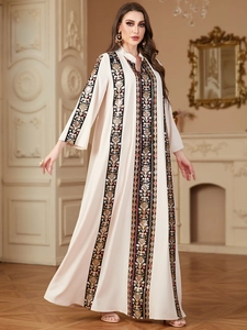 Detailed close-up of intricate ethnic embroidery and V-neckline on this cream kaftan dress