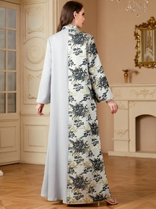 Close-up of contrast splicing and intricate black and gold floral embroidery on the abaya
