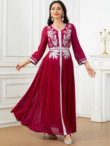 Detailed silver floral embroidery on a burgundy long-sleeved elegant maxi dress