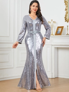Detailed macro view of silver sequin fabric and woven belt on V-neck kaftan maxi dress