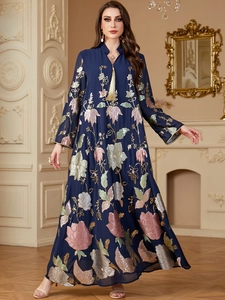 Detailed embroidery and sequins with golden tassels on a dark blue long-sleeved dress