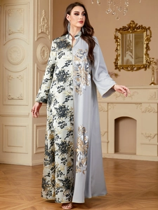 Detail of elegant contrast stitching and luxury floral embroidery on this kaftan dress