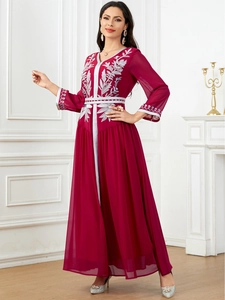 Detailed silver embroidery on the bodice and cuffs of a burgundy chiffon kaftan dress