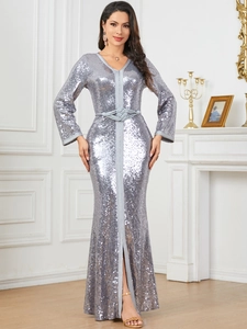 Detailed macro shot of shimmering silver sequins and elegant knot belt on a V-neck maxi dress