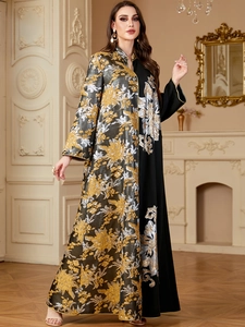 Detail of jacquard long dress with asymmetric gold and silver floral embroidery
