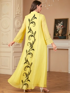 Rear view of yellow elegant embroidered maxi dress with black floral patterns and lace cuffs
