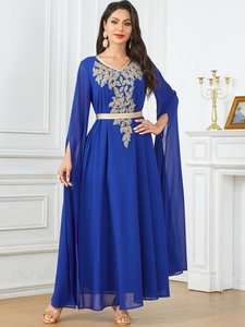 Close-up of royal blue maxi dress with gold leaf embroidery and slit sleeve details