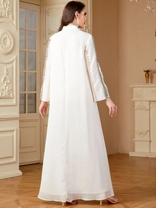 Close-up of white chiffon Abaya with colorful sleeve embroidery and sequin details