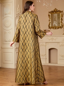 Detail of the back view of a gold and black geometric jacquard kaftan with v-neck