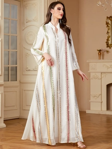 Detail of white chiffon abaya featuring vertical colorful stripes and gold sequins