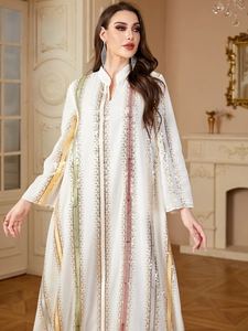 Detailed embroidery and sequins texture on white chiffon dress with long sleeves