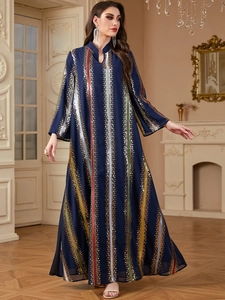 Detail of navy chiffon kaftan dress featuring vibrant vertical sequin stripes and V-neckline
