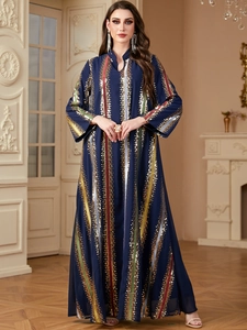 Close-up of luxury navy blue kaftan featuring colorful sequin stripes and fine embroidery
