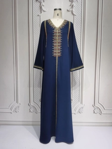 Detail of navy blue kaftan with gold embroidery and beadwork on the bodice and sleeves