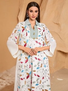 Women's white embroidered long sleeve maxi dress with colorful leaf patterns and sequins