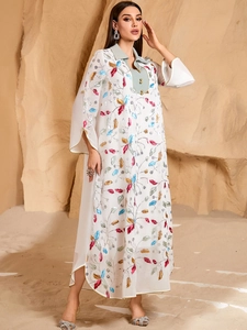 White embroidered kaftan dress with long sleeves and colorful leaf patterns for summer