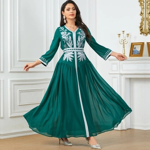 Elegant emerald green kaftan dress featuring silver leaf embroidery and flared long sleeves