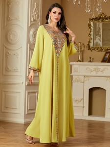 Detailed embroidery with sequins and ethnic patterns on a lemon yellow kaftan dress